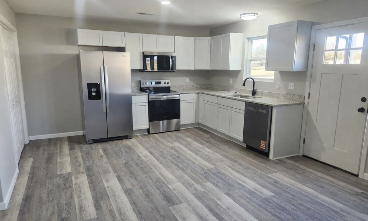 Kitchen and open living area at 1804 Country Manor Street